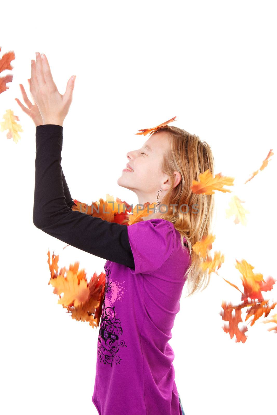 Girl and falling autumn leaves against white background