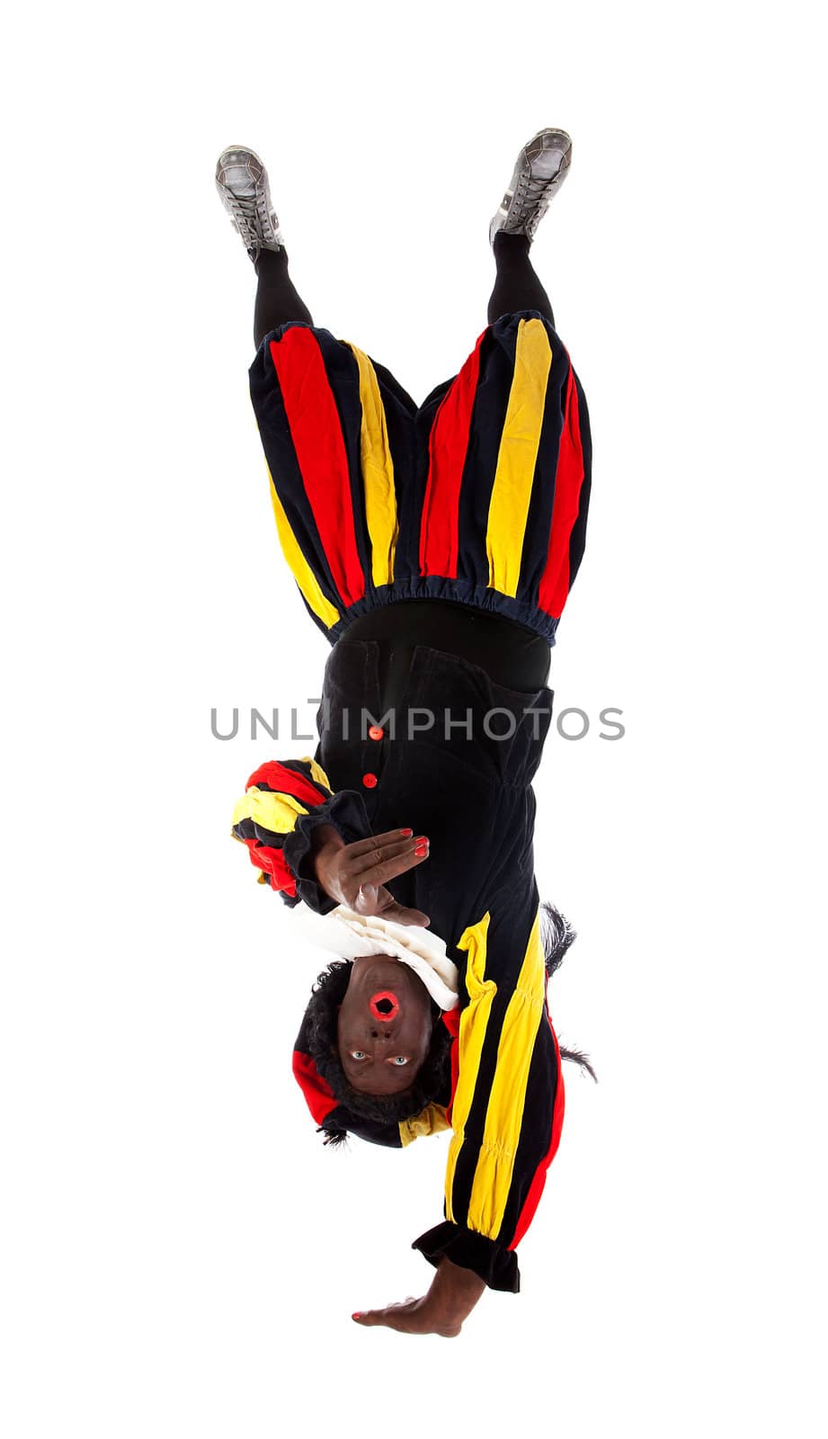Zwarte piet ( black pete) typical Dutch character part of a traditional event celebrating the birthday of Sinterklaas in december over white background upside down is pointing