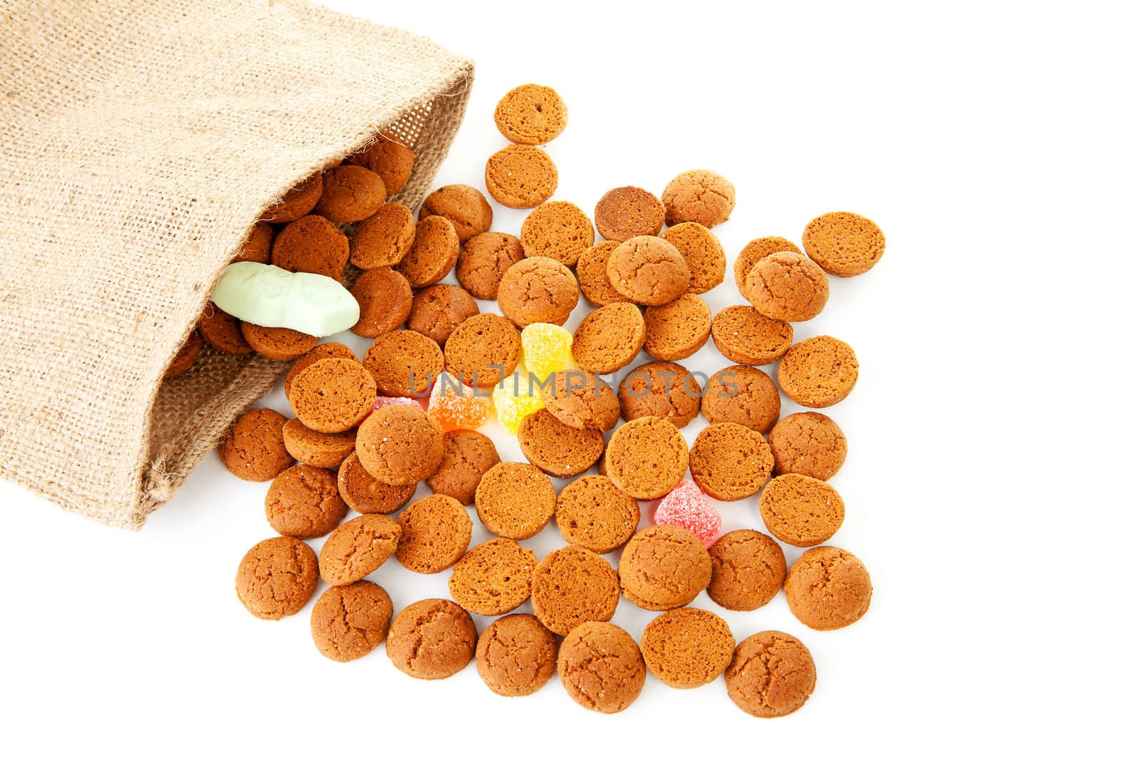bag with typical dutch sweets: pepernoten (ginger nuts) for a celebration at 5 december in the Netherlands over white background