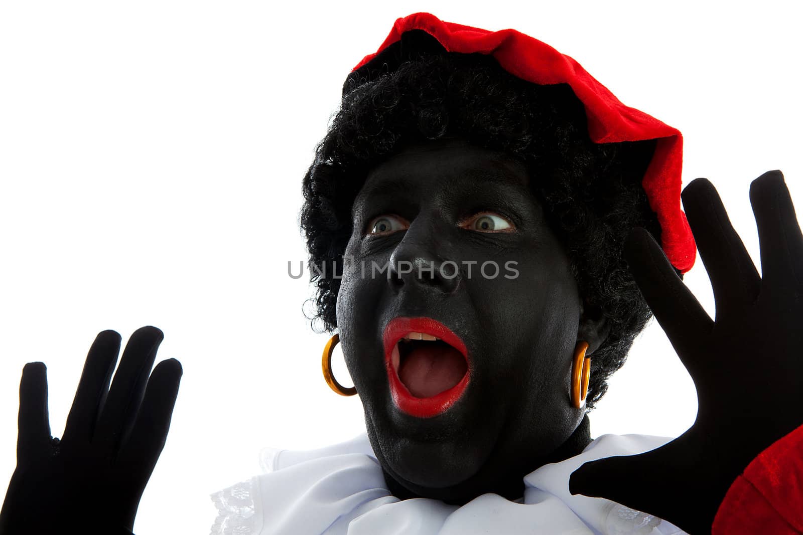 Zwarte piet ( black pete) typical Dutch character part of a traditional event celebrating the birthday of Sinterklaas in december over white background is looking surprised