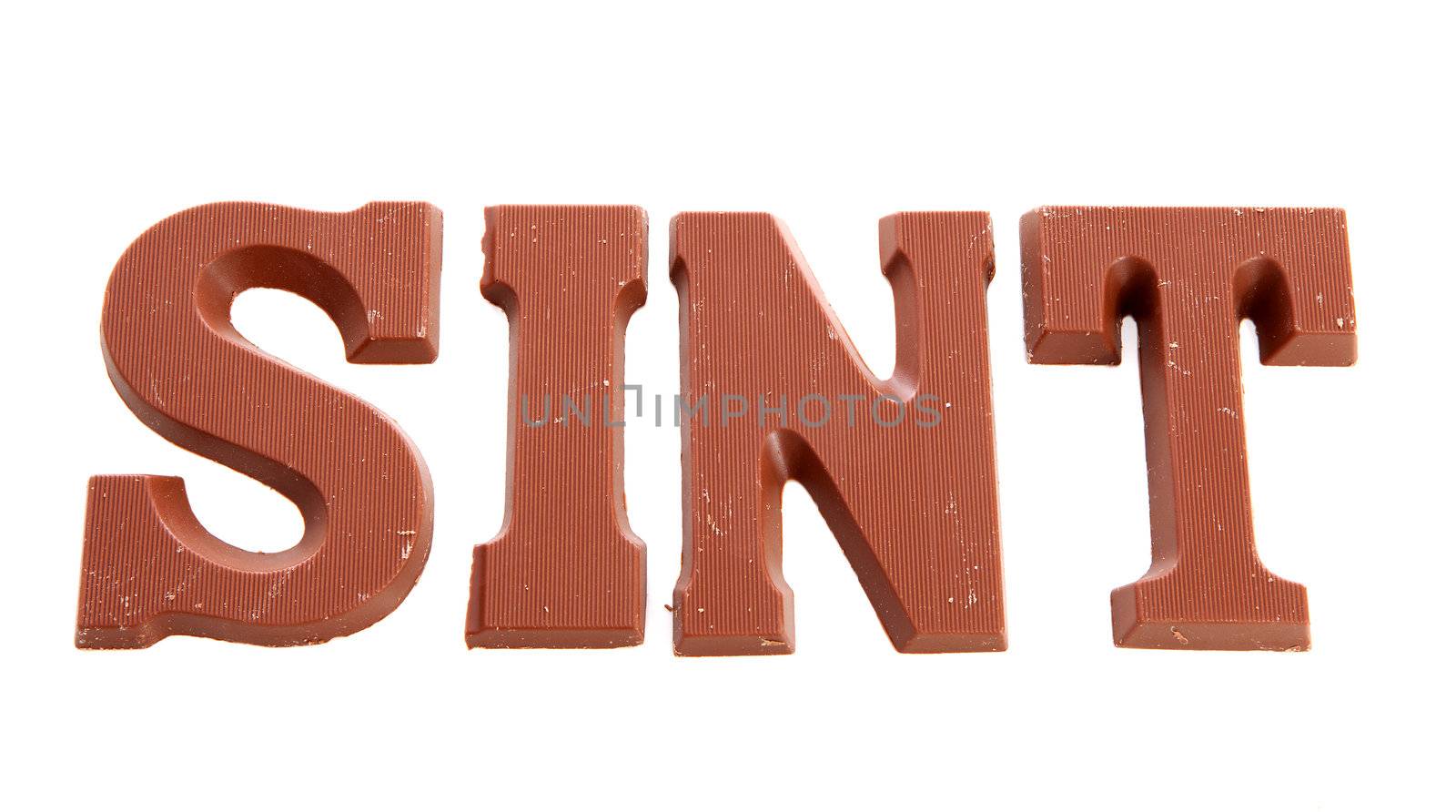 The word "Sint" in chocolate letters isolated on white background, typical Dutch candy for Sinterklaas event in december 
