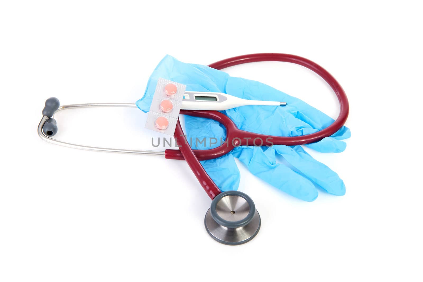 Medical tools with gloves, stethoscope, pills and thermometer over white background