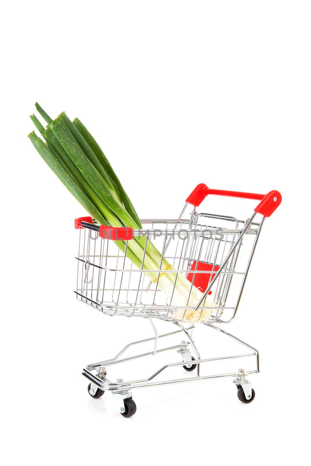 Shopping cart with spring onions over white background