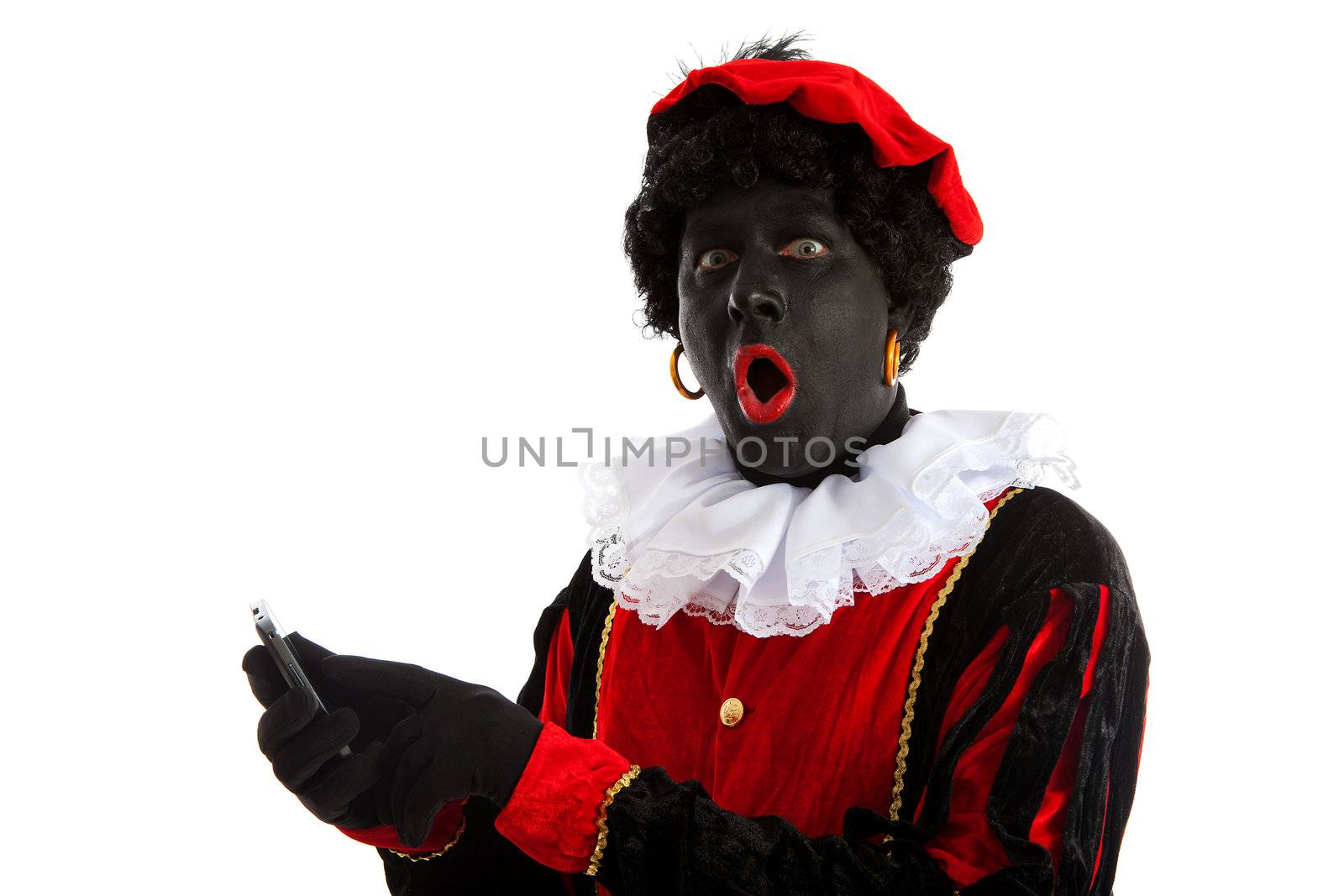 Zwarte piet ( black pete) typical Dutch character part of a traditional event celebrating the birthday of Sinterklaas in december over white background with mobile phone