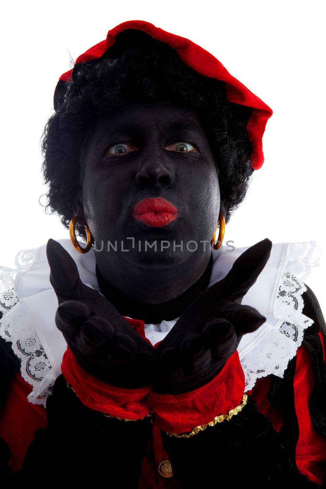 Portrait of kissing Zwarte piet ( black pete) typical Dutch character part of a traditional event celebrating the birthday of Sinterklaas in december over white background