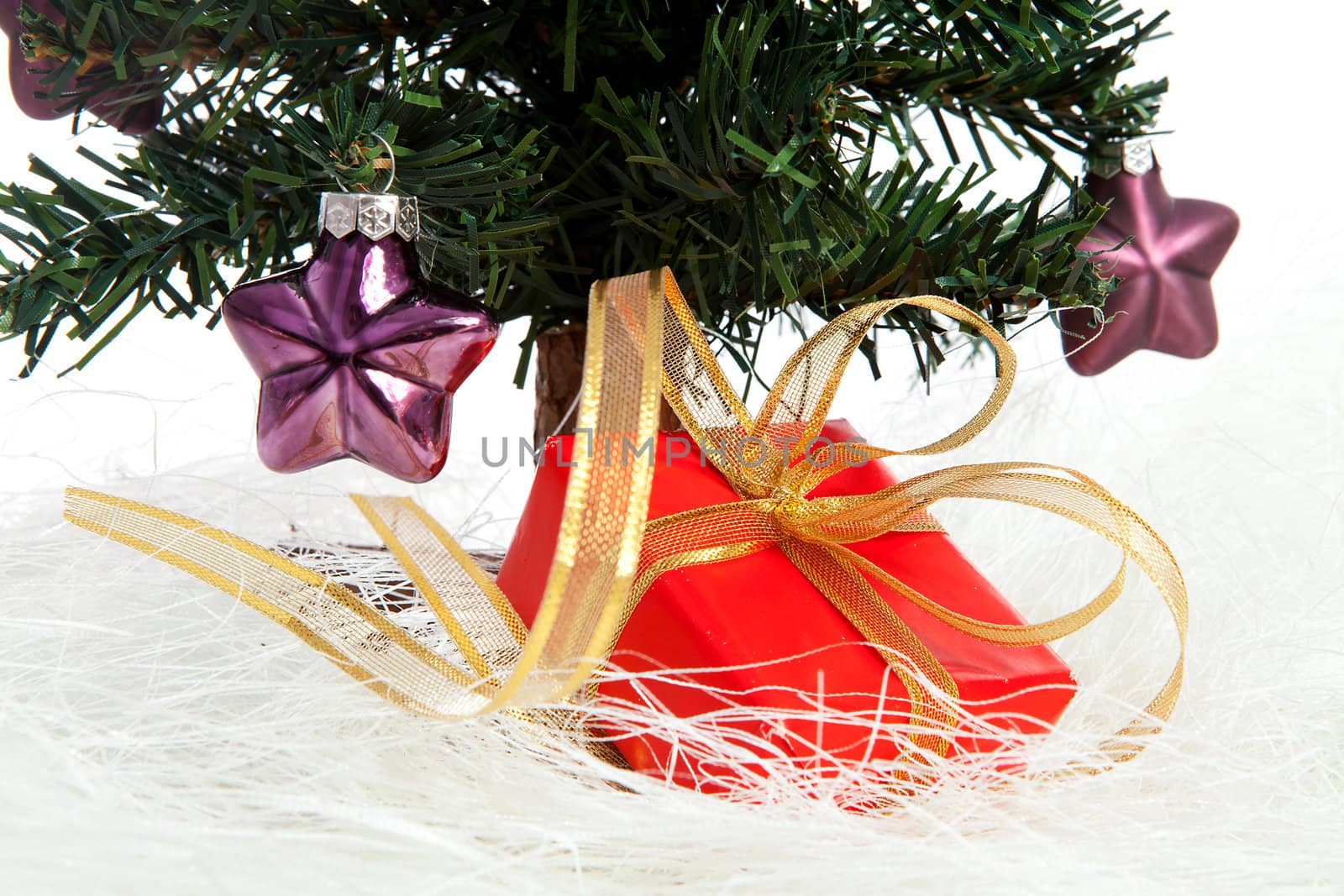 plastic christmas tree with purple stars and red present isolated on white background