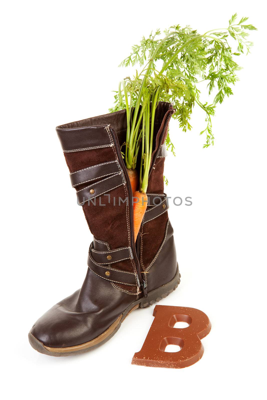 Boot with carrot and chocolate letter  for Dutch traditional feast: Sinterklaas over white background