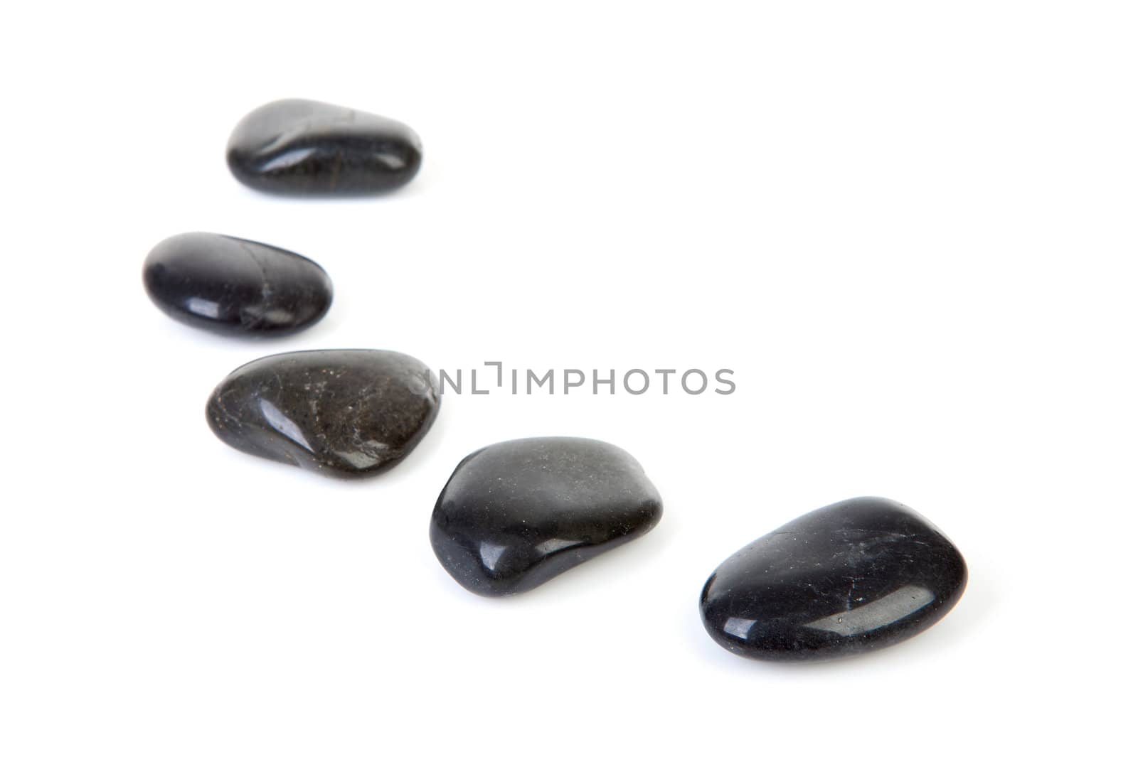 Black stepping stones in a row over white background 
