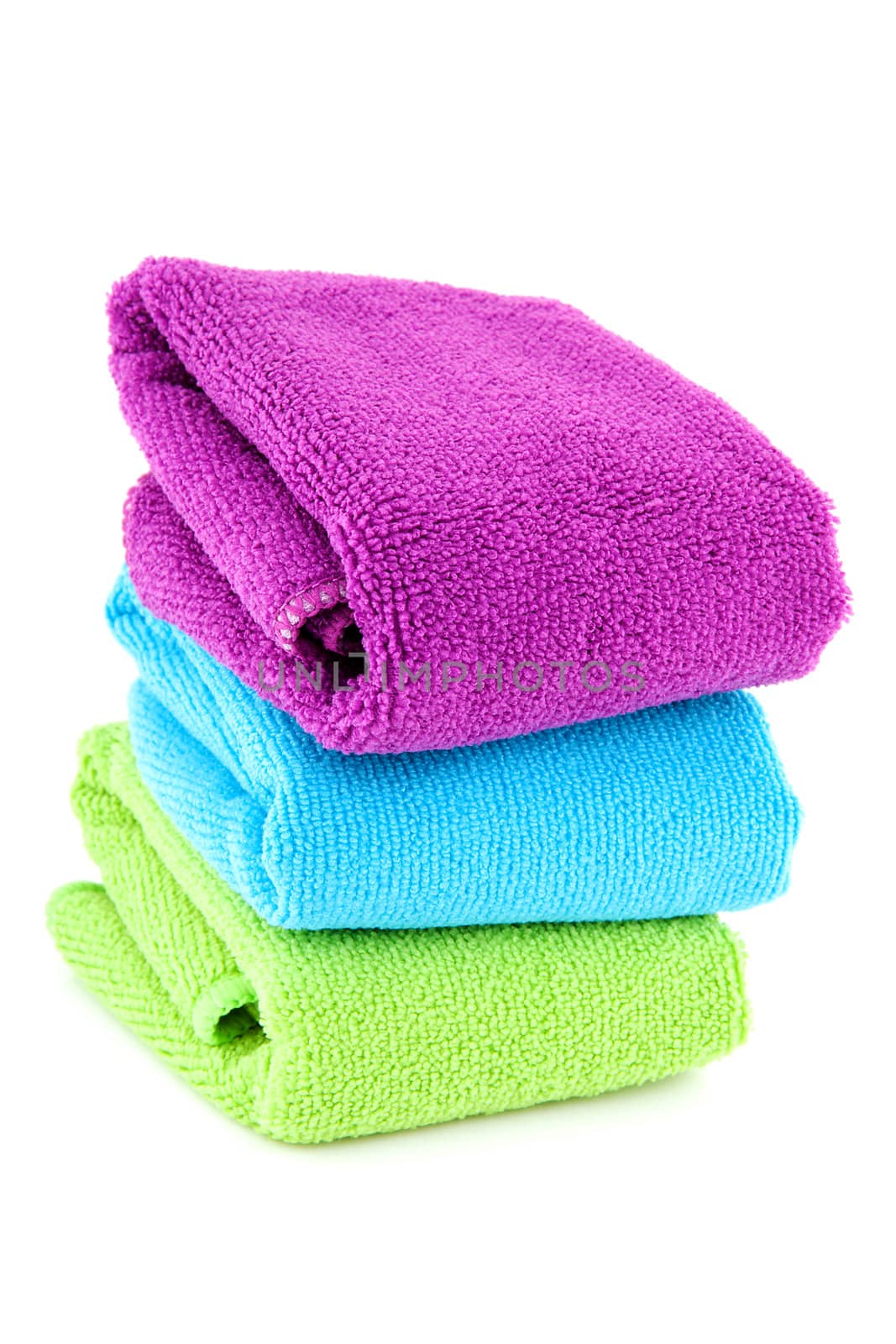 stacked colorful folded towels over white background