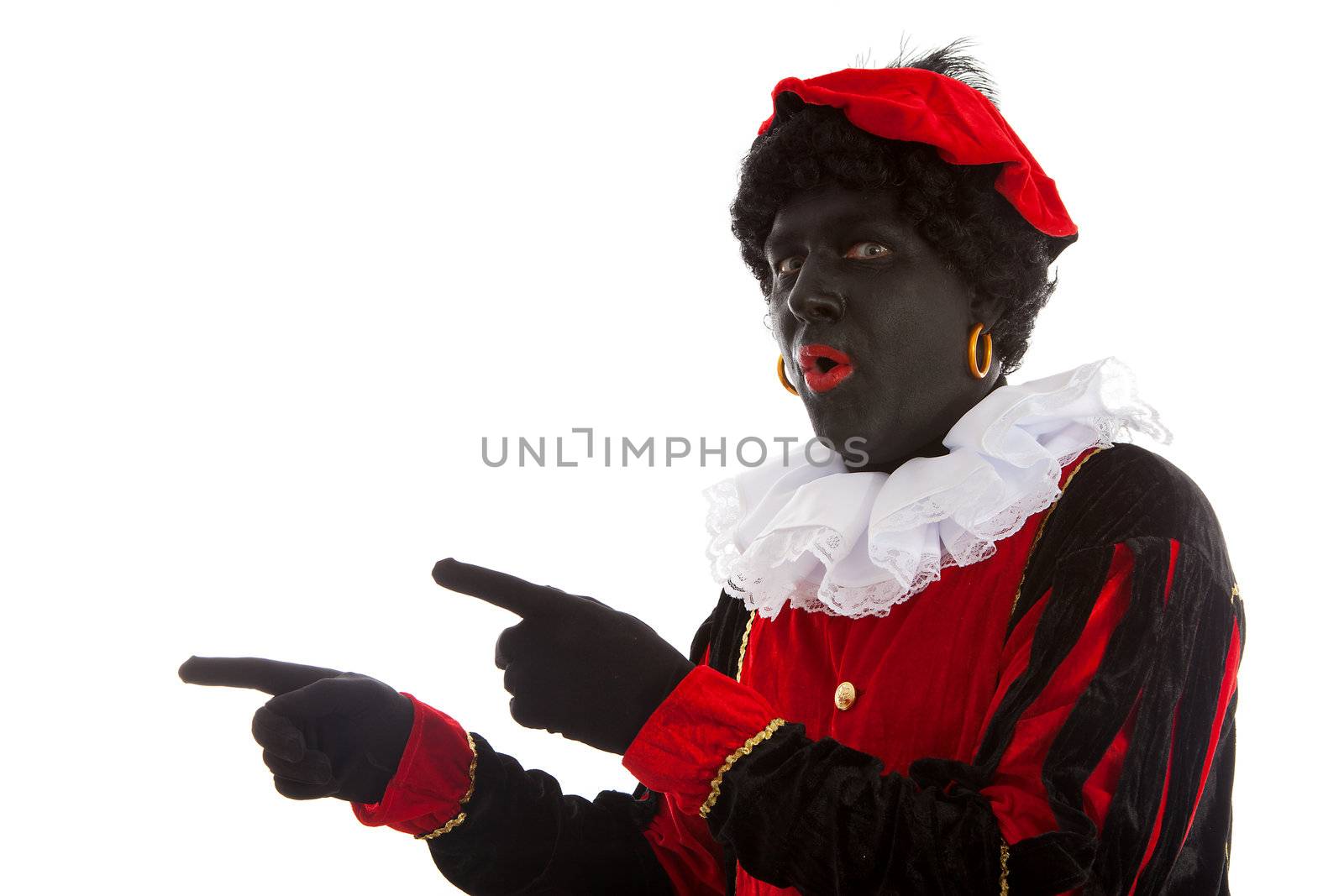 surprised Zwarte piet ( black pete) typical Dutch character part of a traditional event celebrating the birthday of Sinterklaas in december over white background is pointing 
