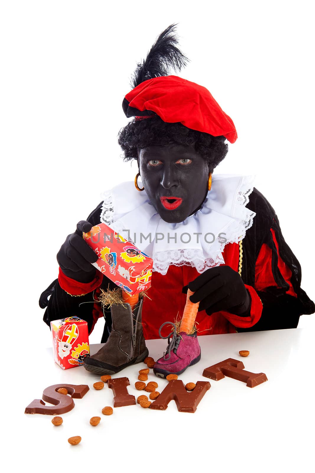 Sinterklaas, typical Dutch event with zwarte piet ( black pete) chocolate letters and carrot in shoes over white background