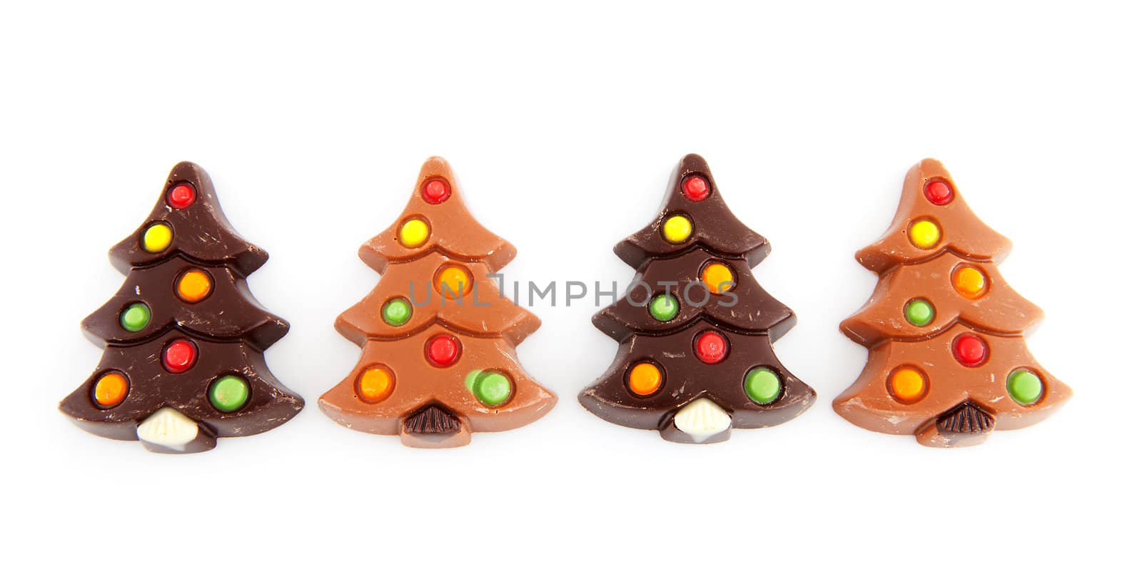 christmas chocolate candy in shape of tree over white background