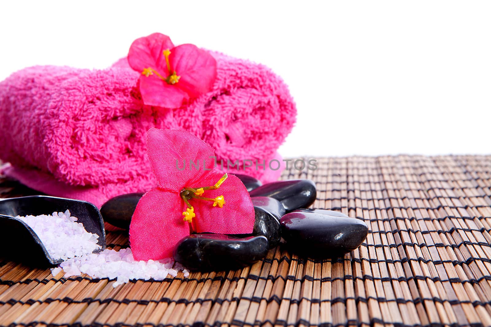 pink spa zen accessories and bamboo on cane mat