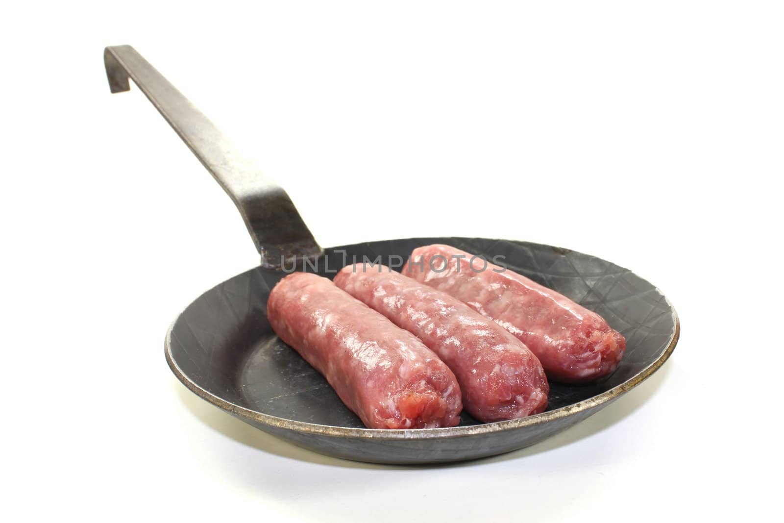 Salsiccia in a pan on bright background