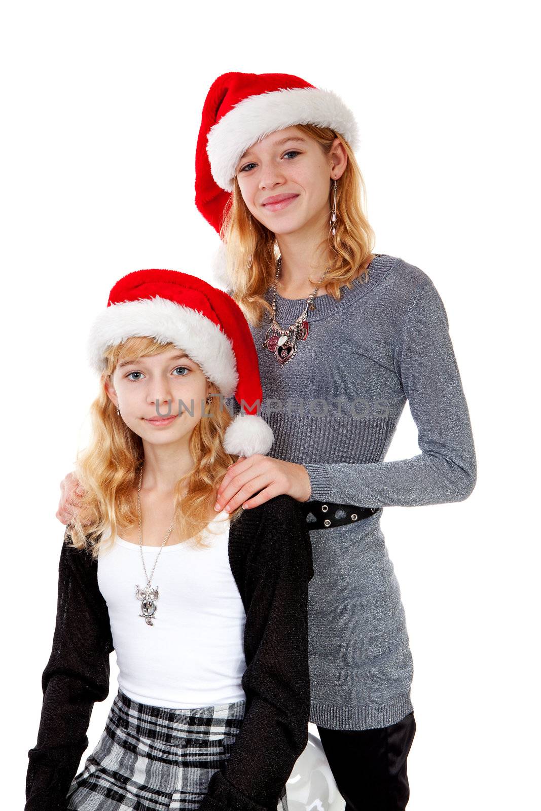 Two girl with christmas hat posing over white background
