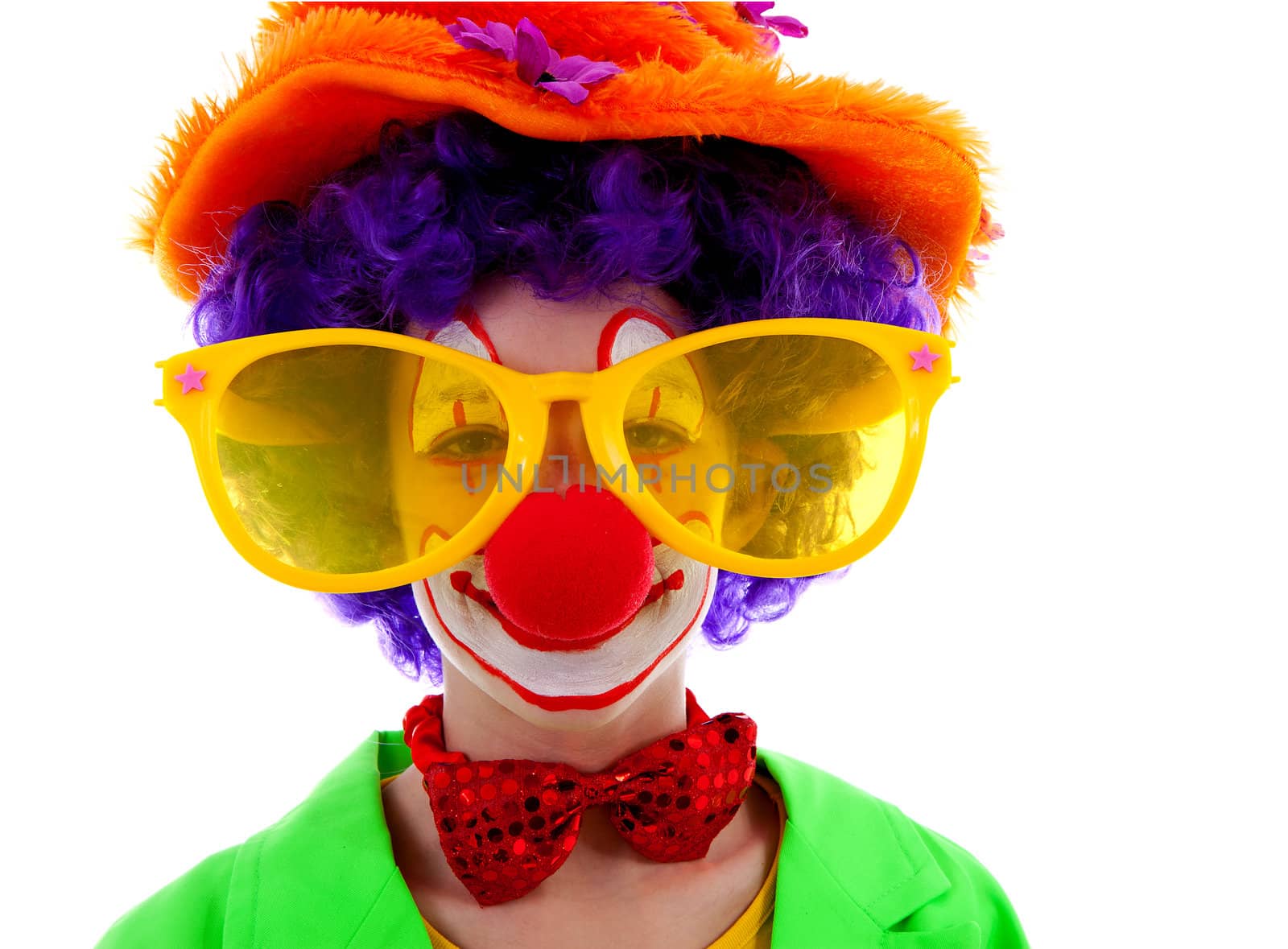 portrait of child dressed as colorful funny clown over white background