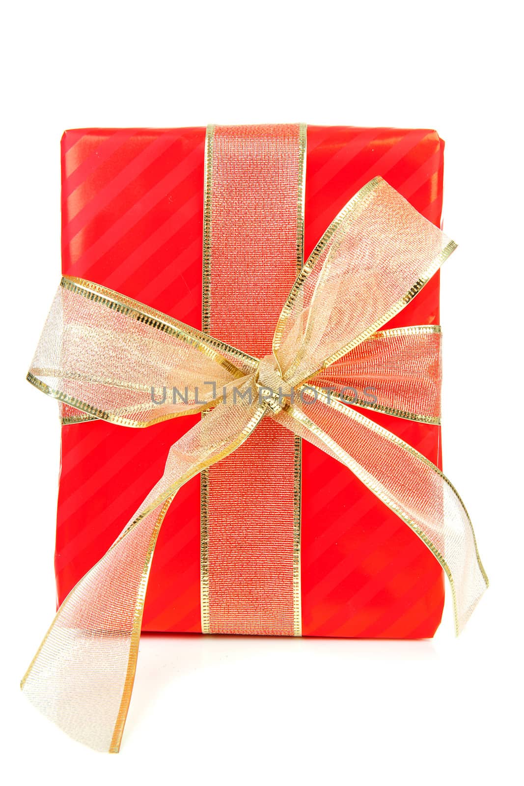 Big red present with golden ribbon over white background