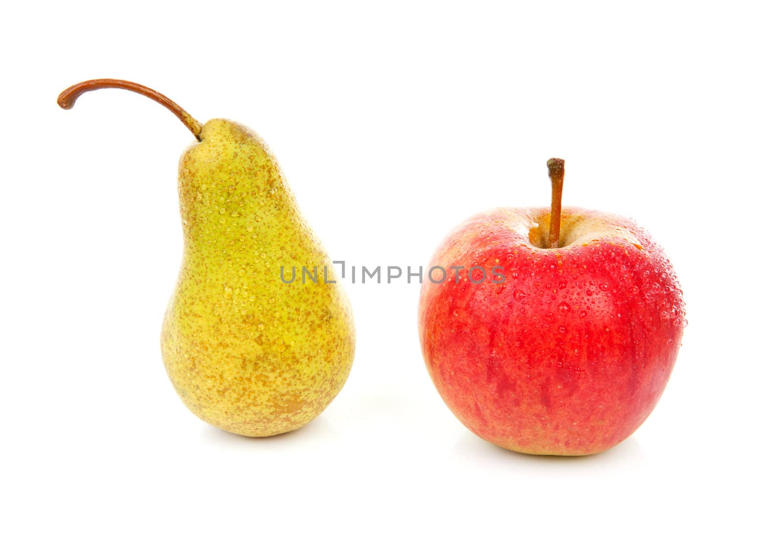 fresh pear and apple with water drops over white background