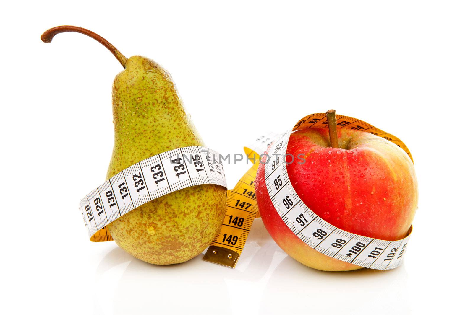 healthy diet; pear and apple with measure tape over white background