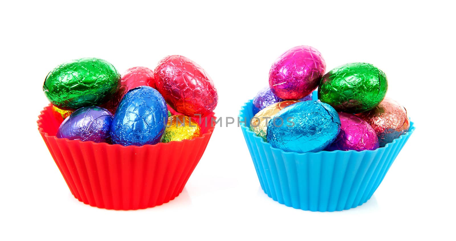 Bowls with colorful easter eggs over white background