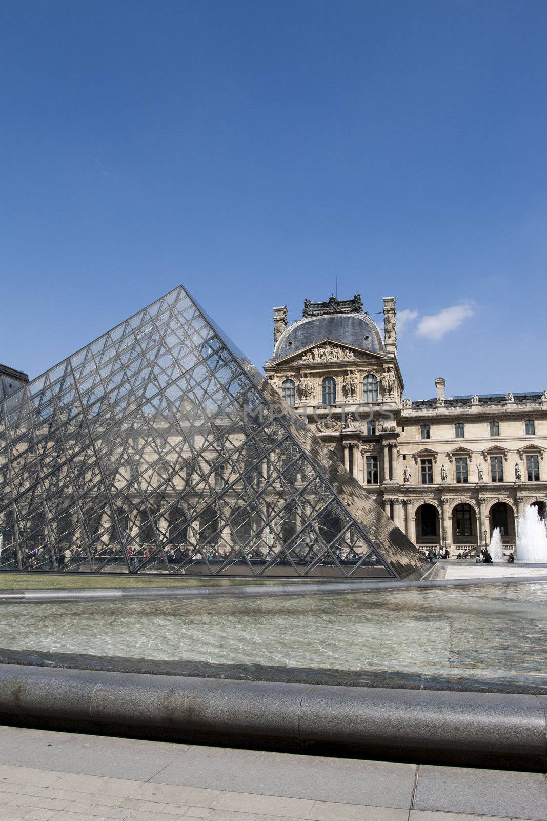 PARIS - APRIL 13, 2008. Glass Pyramid at the Louvre Museum on April 13, 2008. The Louvre is one of the world's largest museums and one of most central landmarks of Paris. Architect I.M.Pei is author of glass pyramid over a new entrance in the main court.