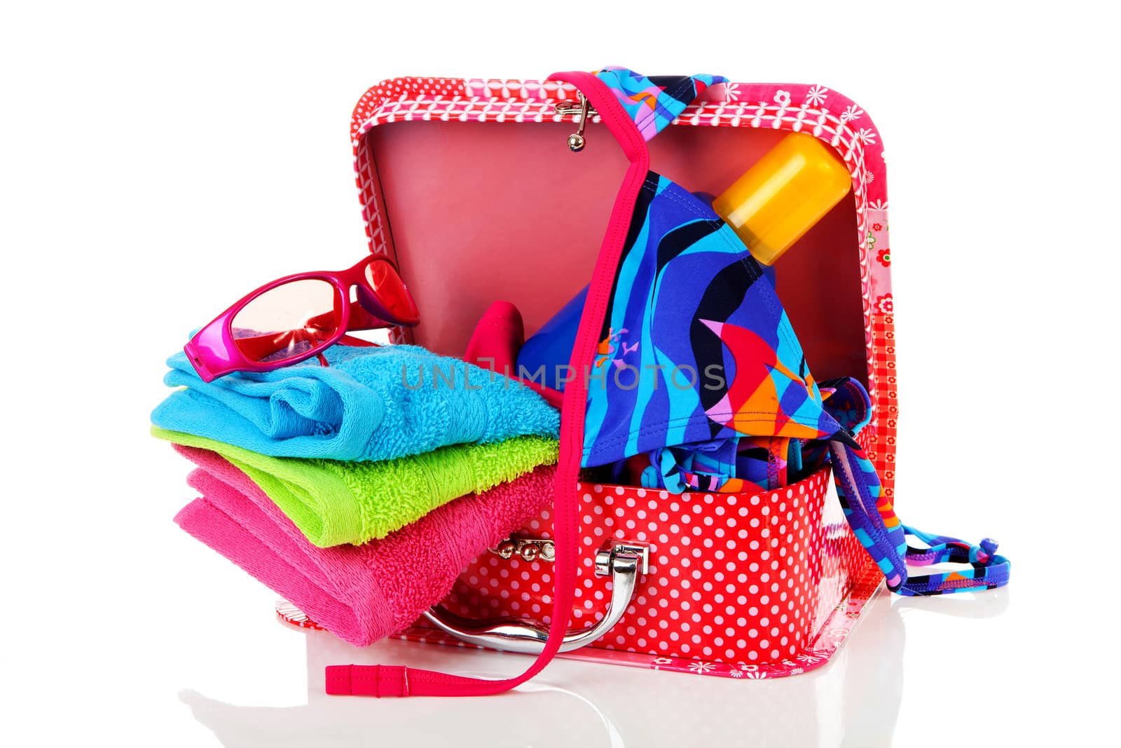 Going on vacation; accessories and suitcase over white background