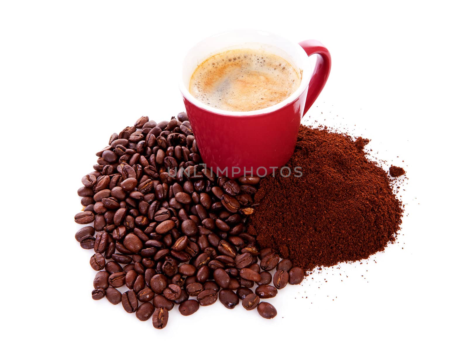 Cup in pile of roasted beans and regular ground coffee over white backgroun