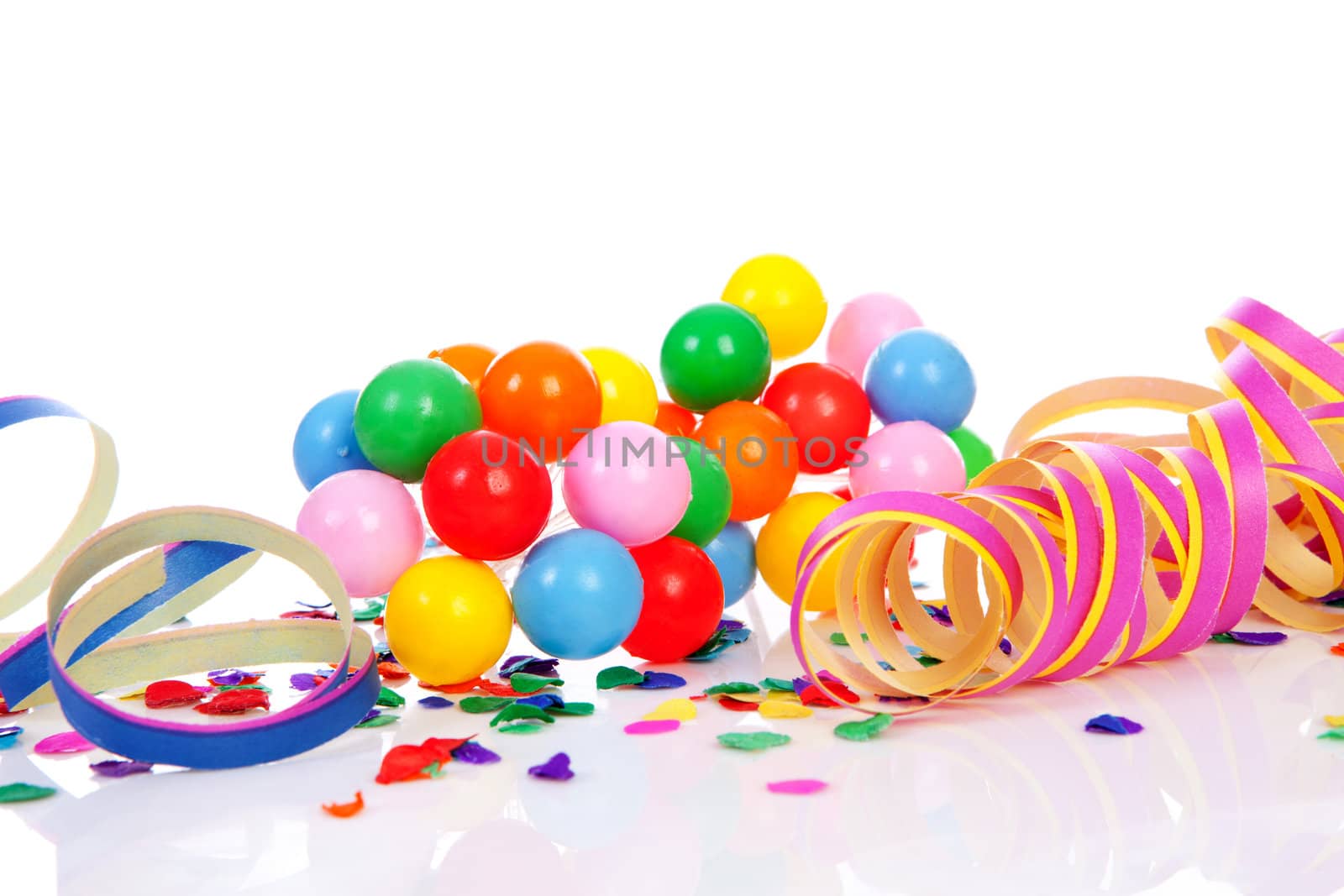 Colorful confetti, balloons and party streamers over white background