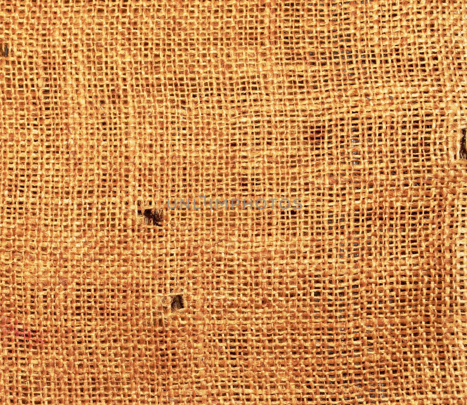 Old torn flaxen sackcloth as natural background