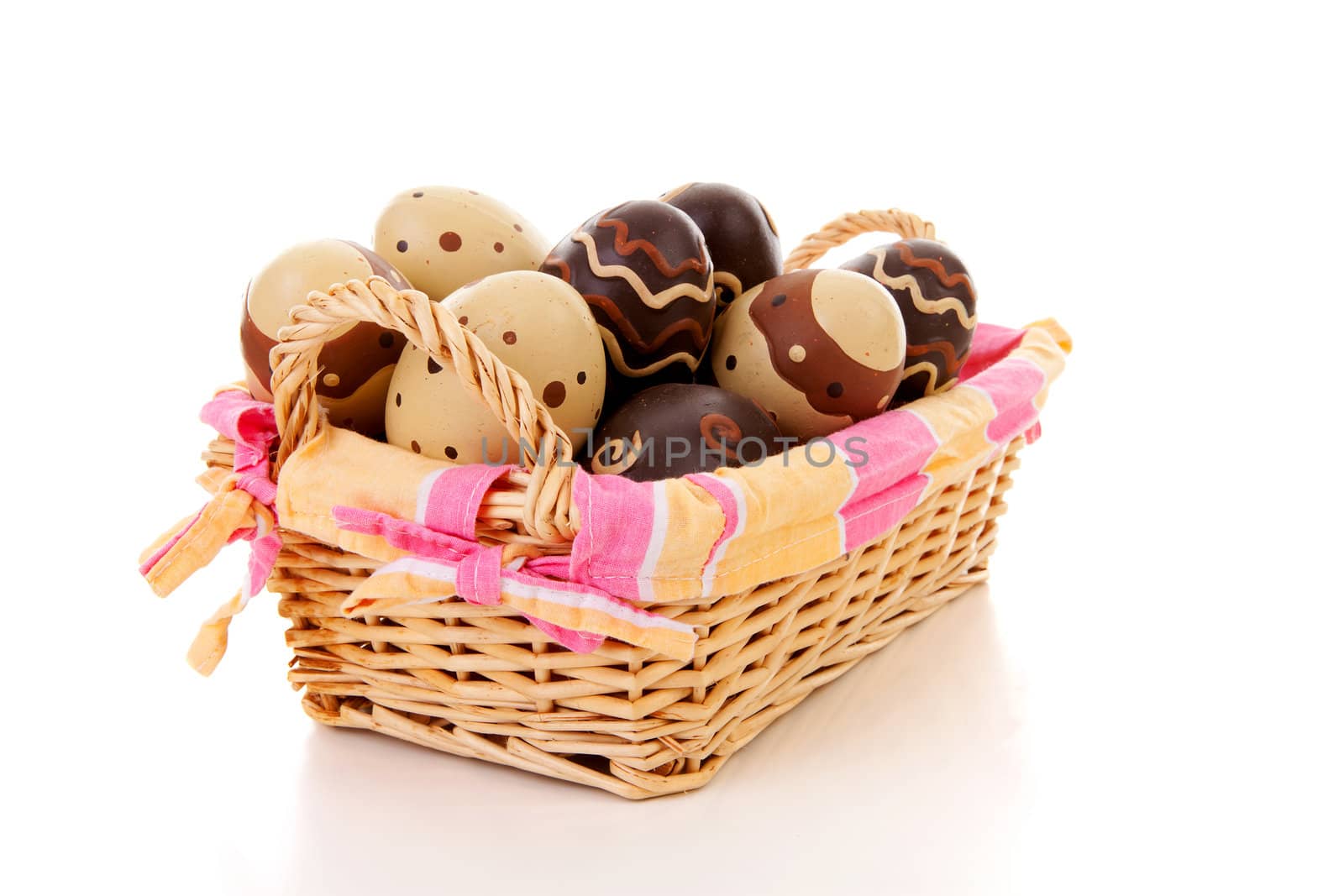 Cane basket with easter eggs over white background