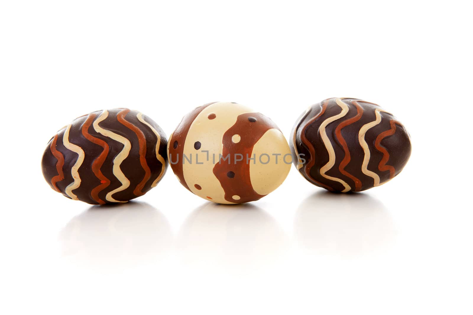 Three brown easter eggs over white background
