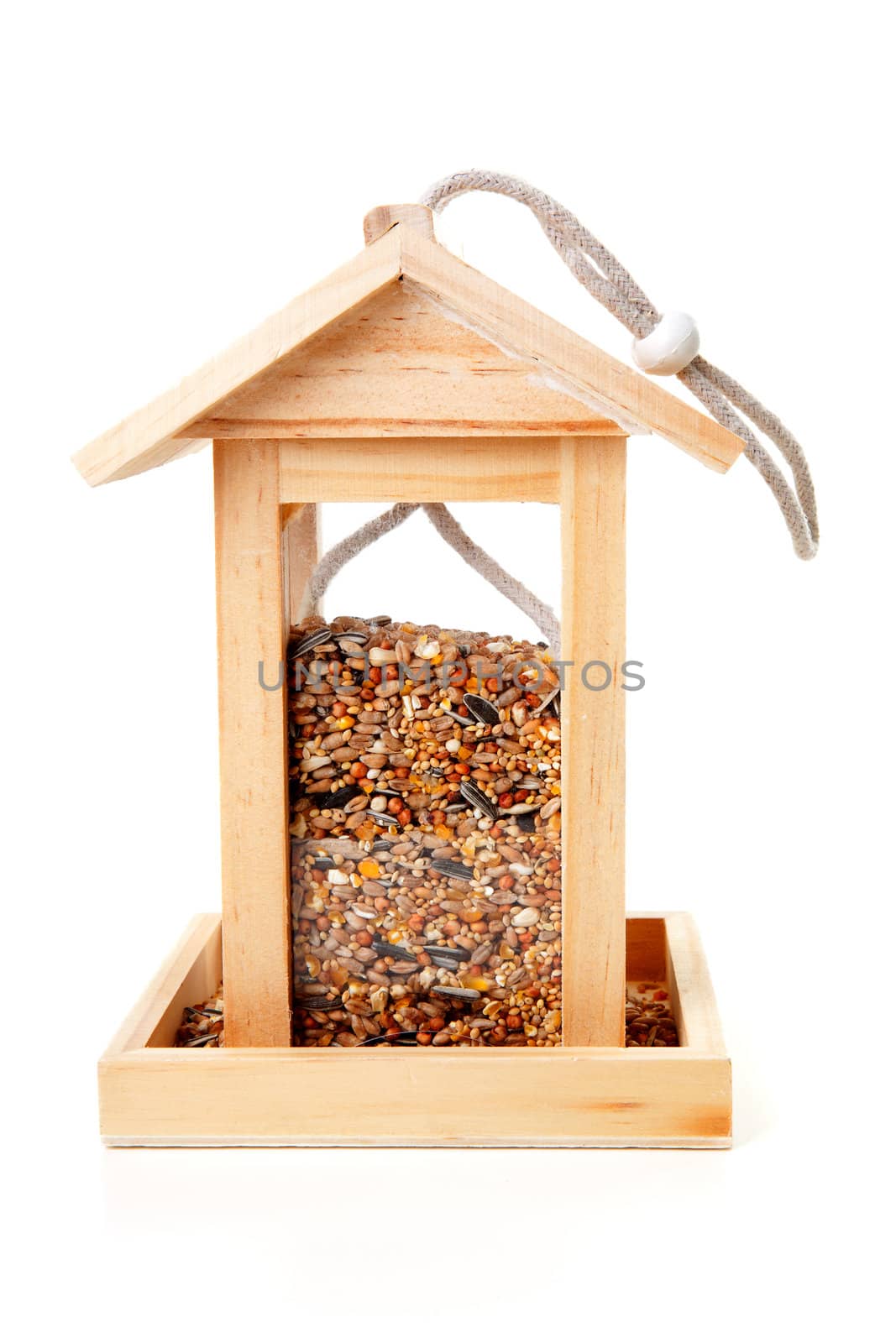 wooden bird feeder house with food over white background