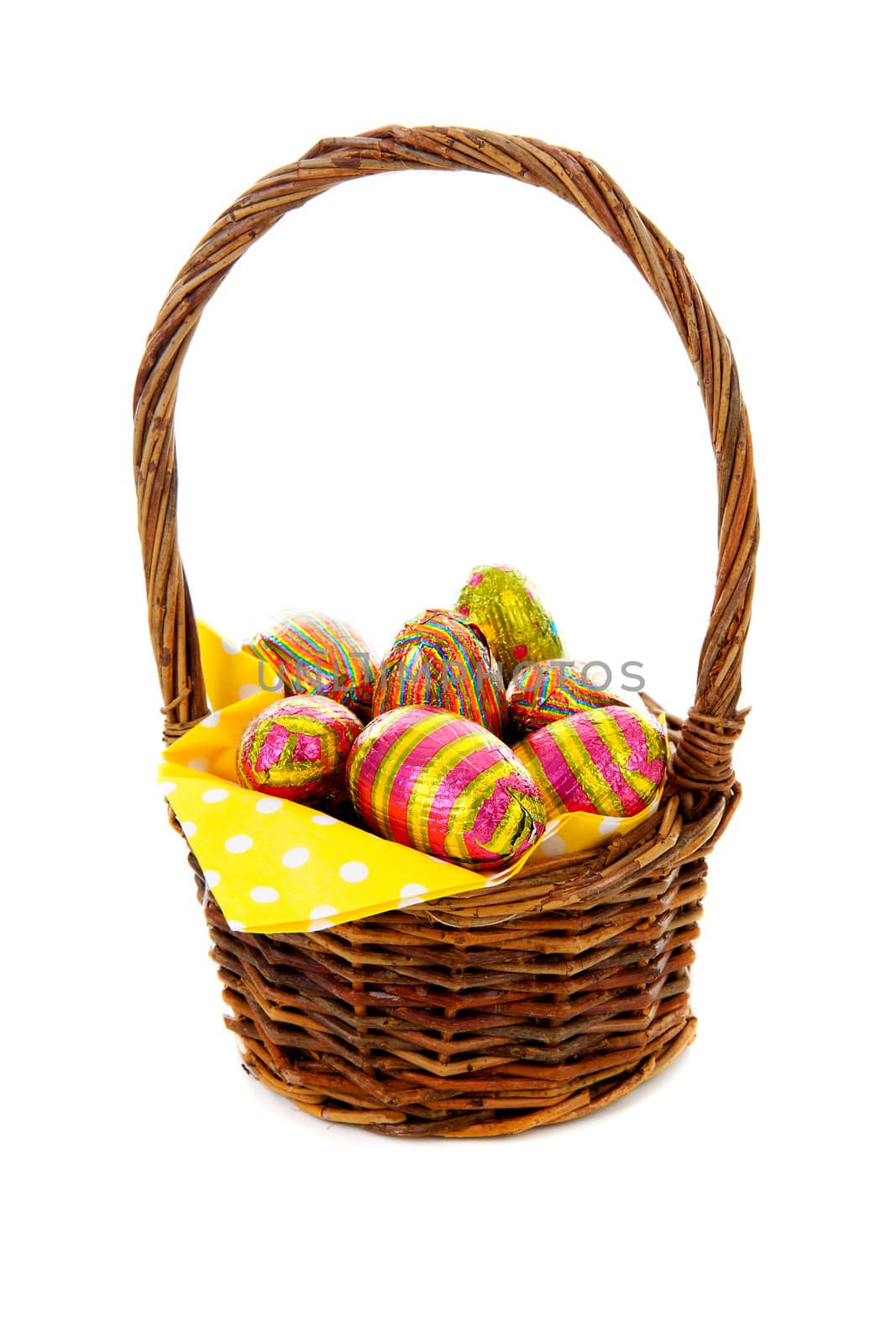 Cane basket with easter eggs over white background