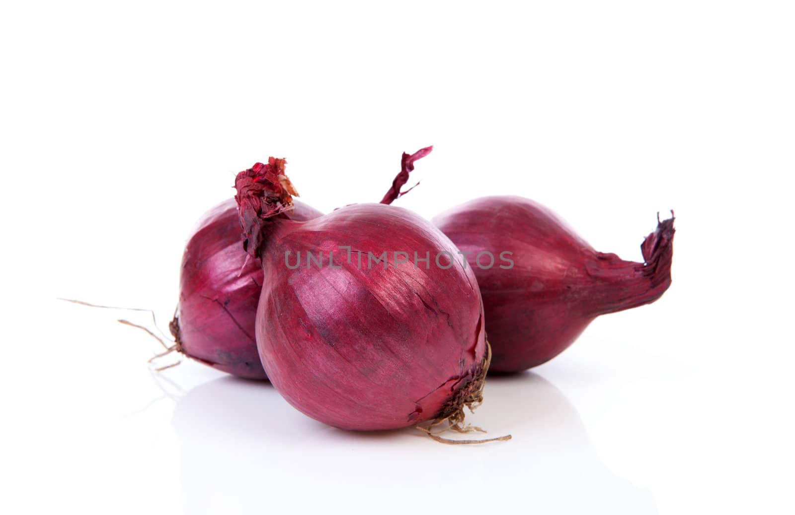 Three red onion isolated on white background