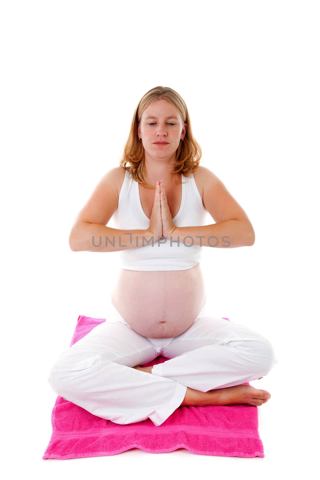 woman doing meditative pregnancy yoga over white background 
