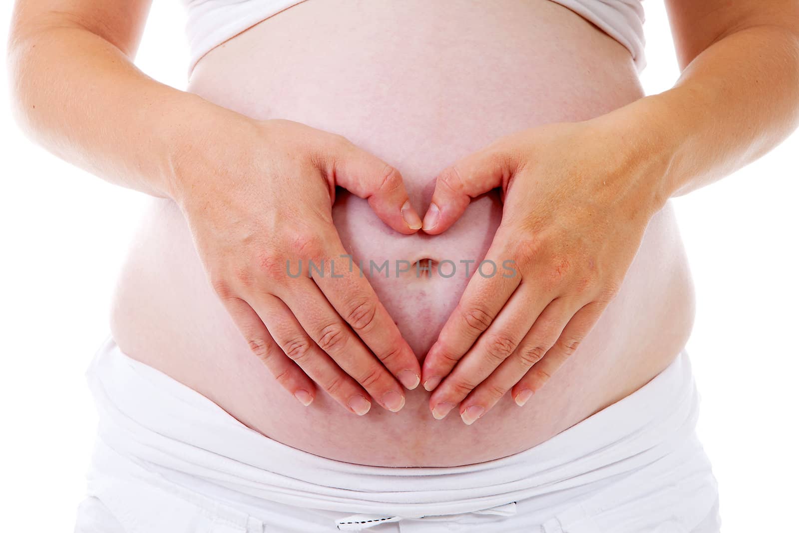 pregnant belly with hands in the shape of hearts over white background
