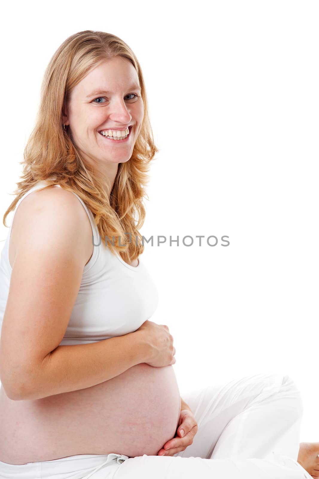 Pregnant women sitting on floor holding belly isolated on white background