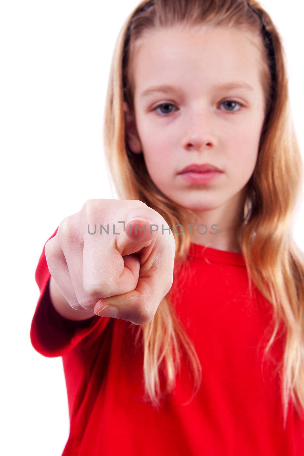 Girl is pointing at you over white background, girl is blur and hand is sharp