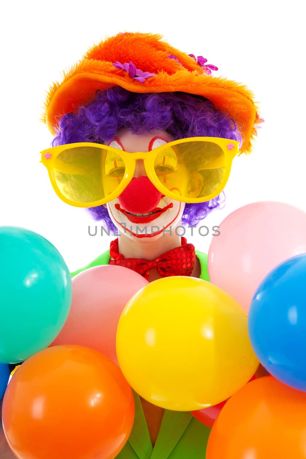 portrait of child dressed as colorful funny clown over white background