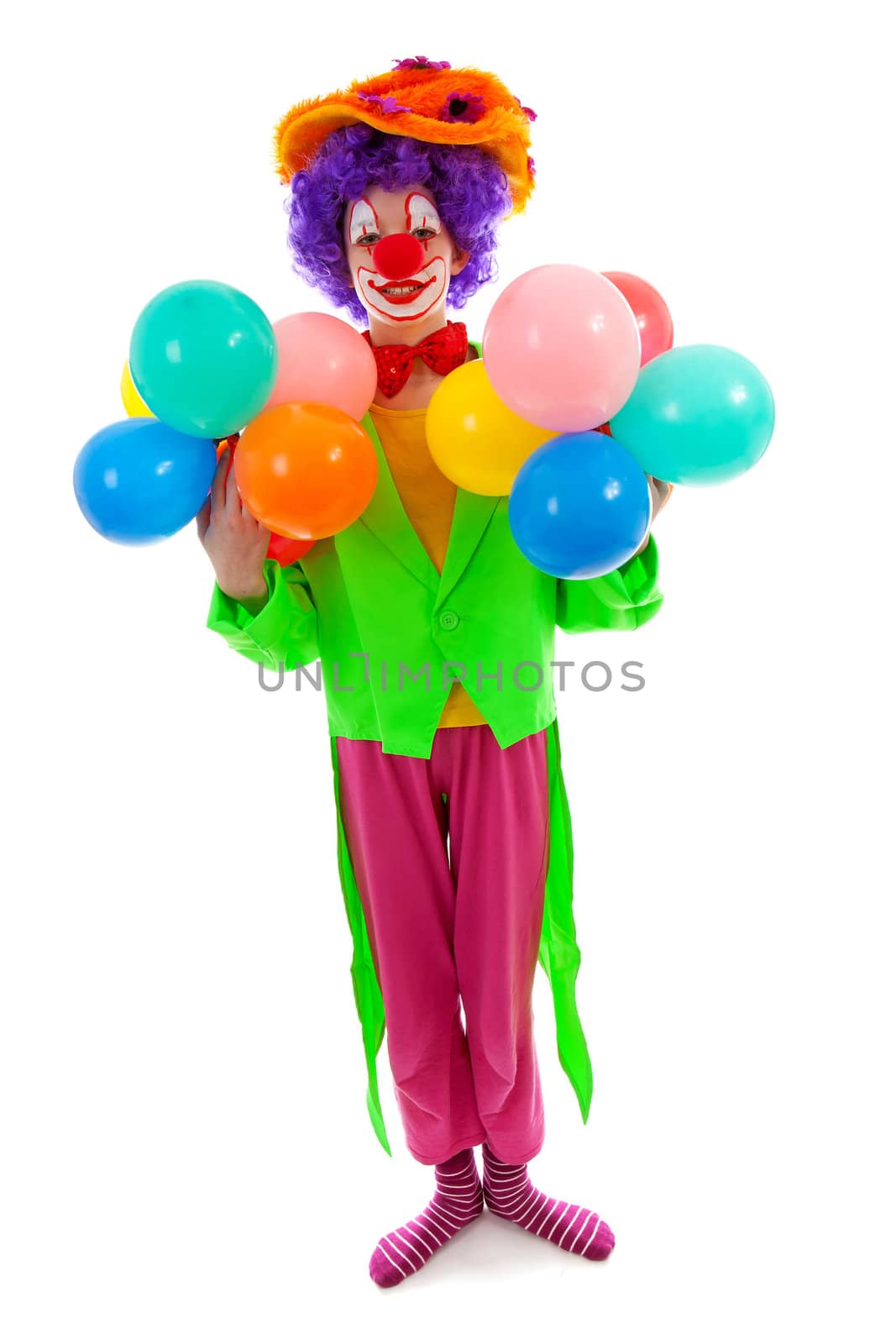 child dressed as colorful funny clown with balloons over white background