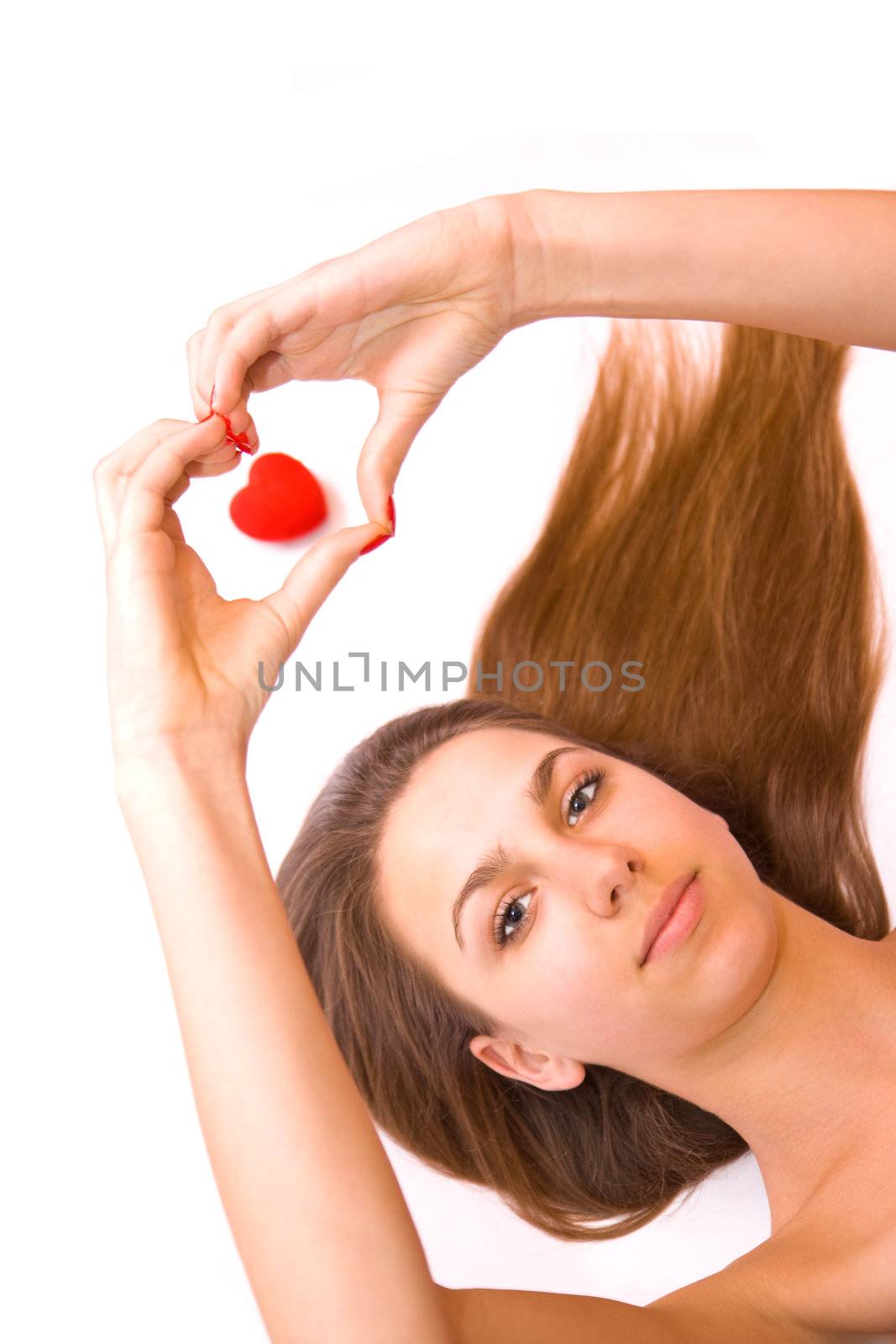 Young teen girl and red heart isolated on white