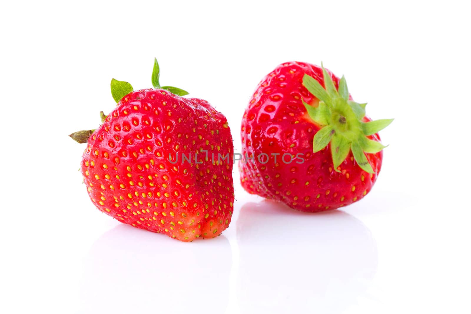 Two strawberries in closeup over white background