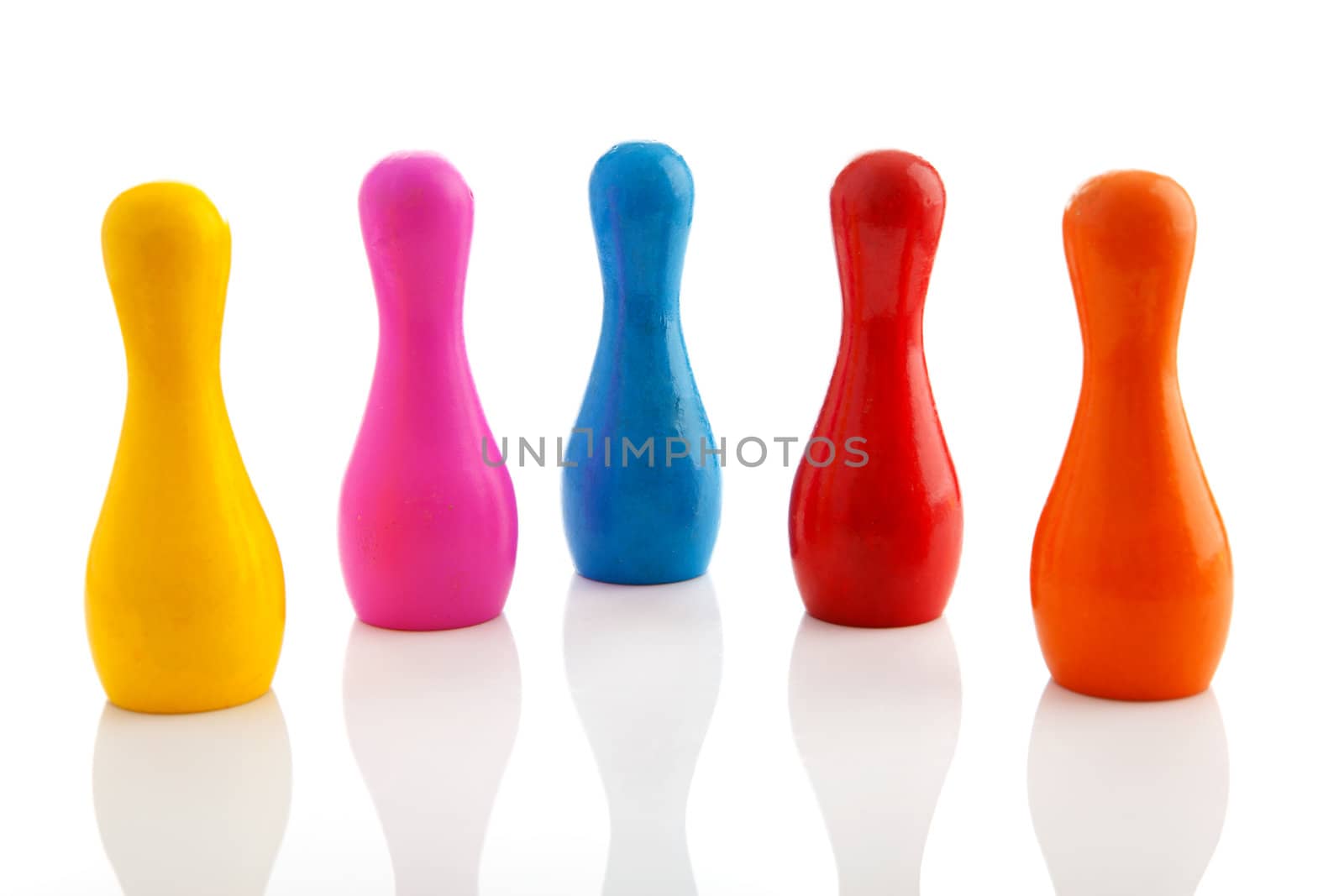 Five colorful bowling pins over white background