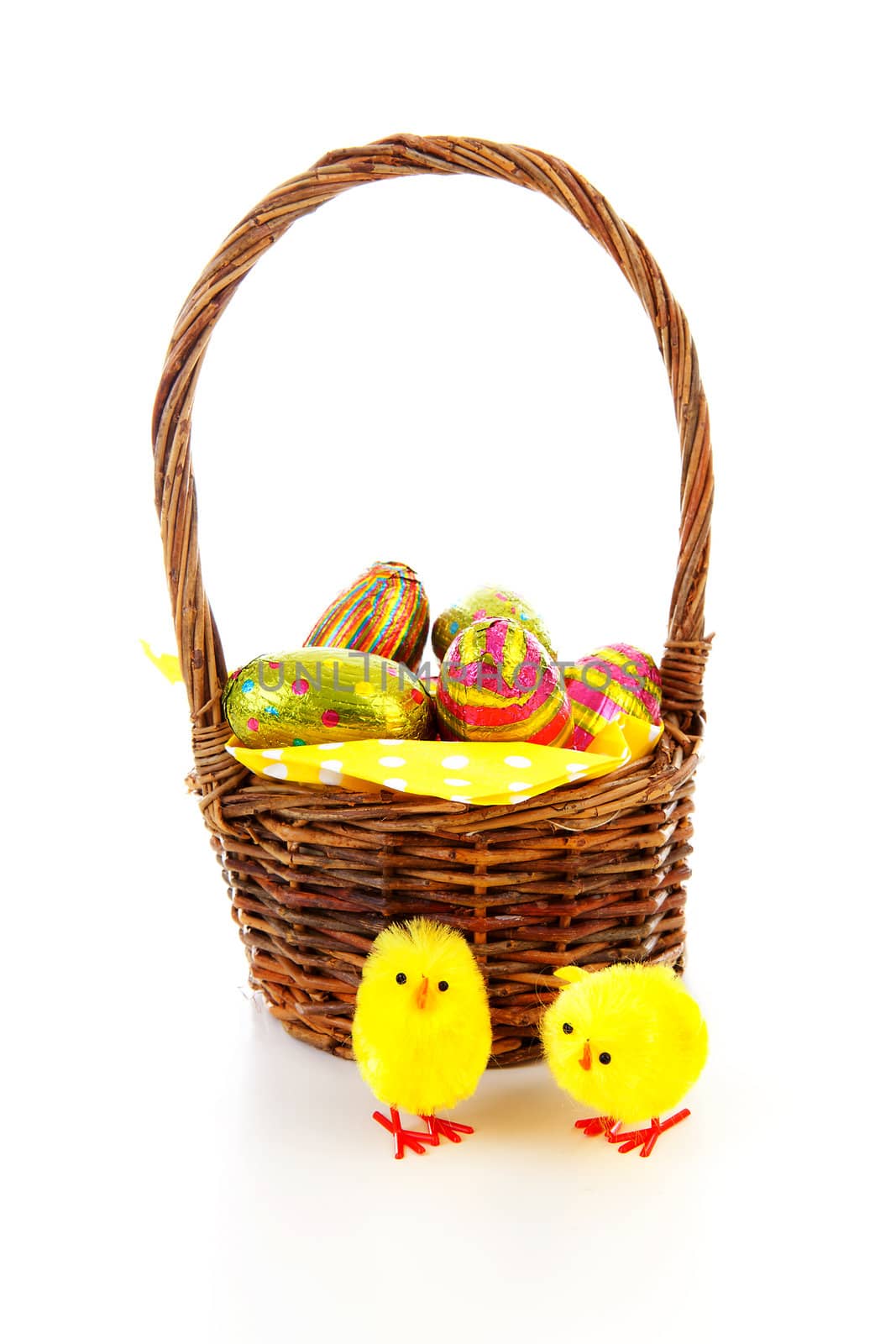 Cane basket with easter eggs over white background