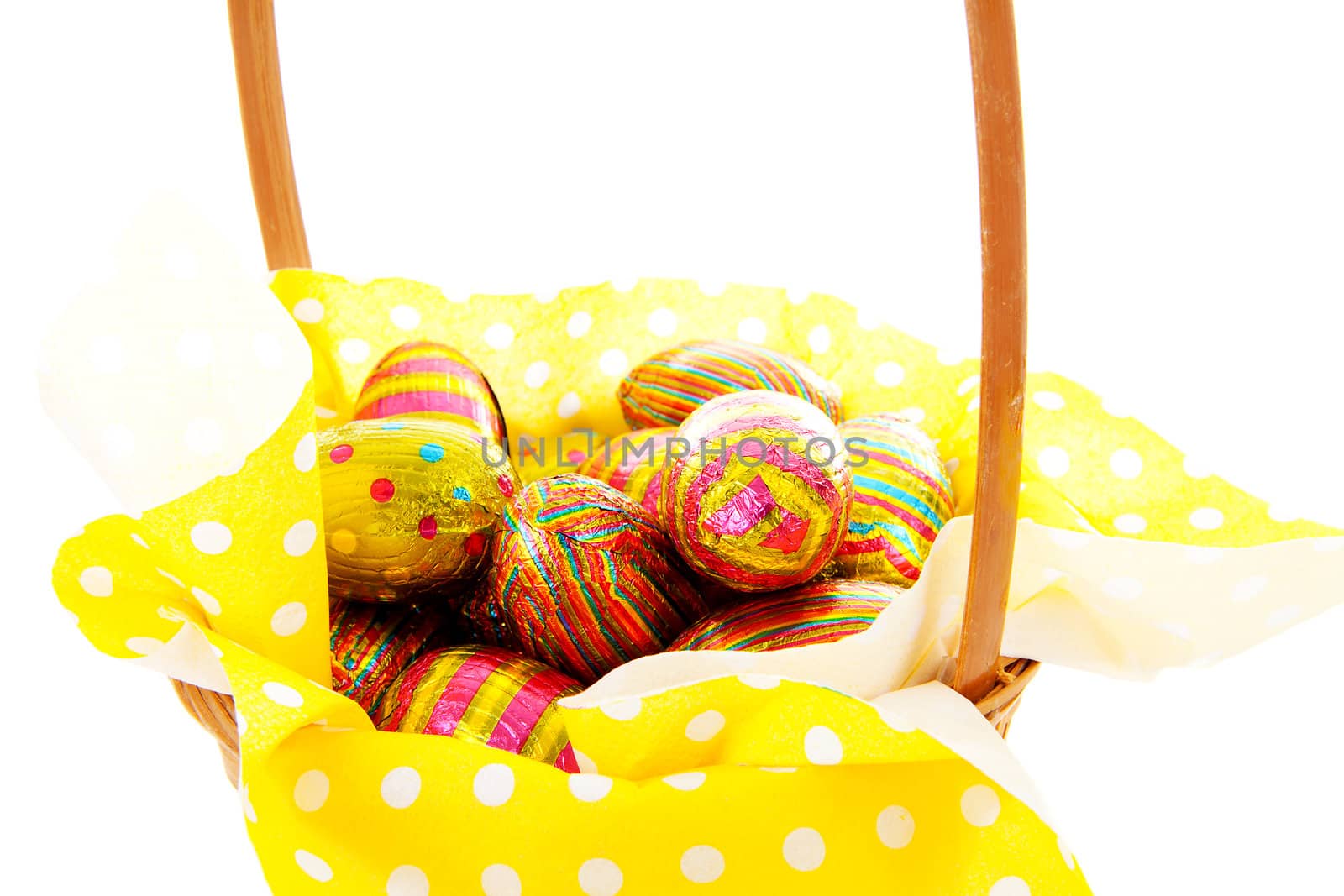 basket with easter eggs in closeup over white background