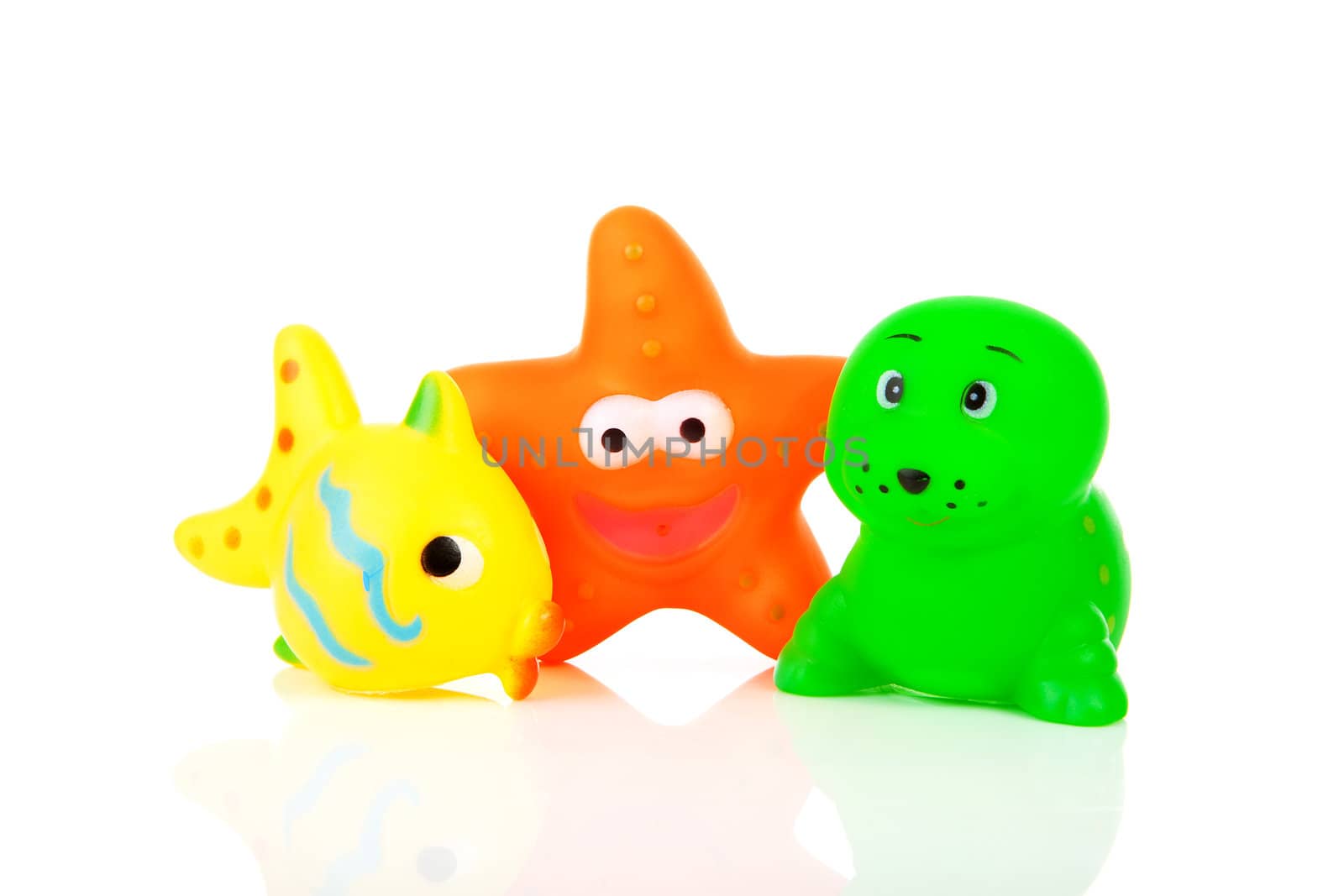 Colorful rubber bath toys over white background