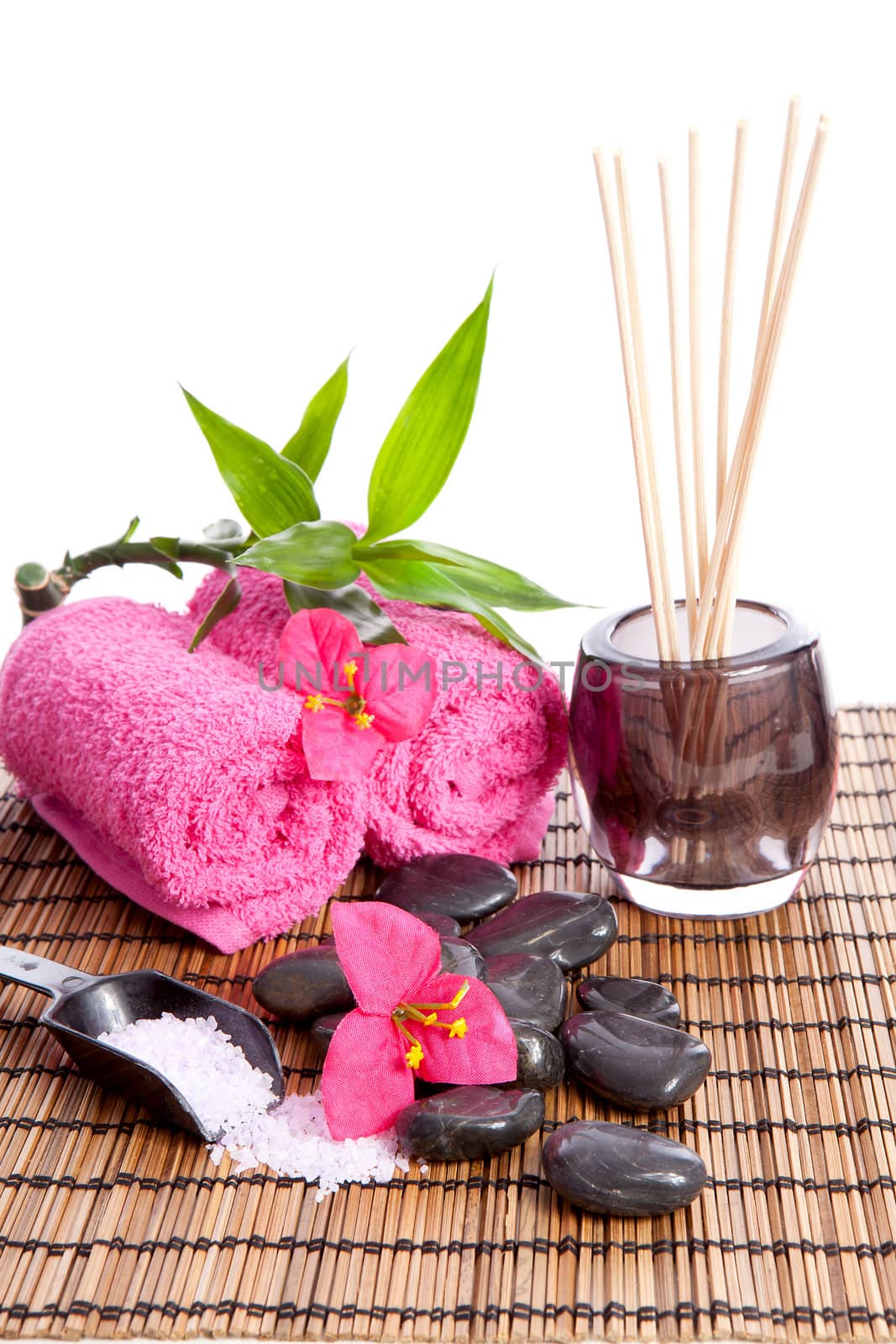 Accessories for spa and beauty on cane mat over white background