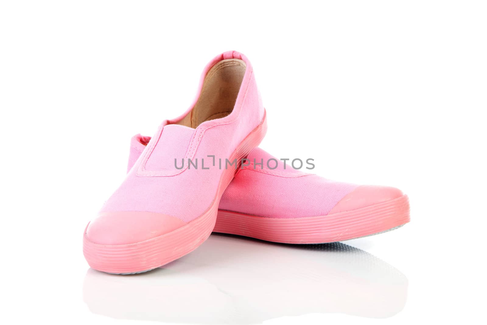 Pair of pink gym shoes over white background