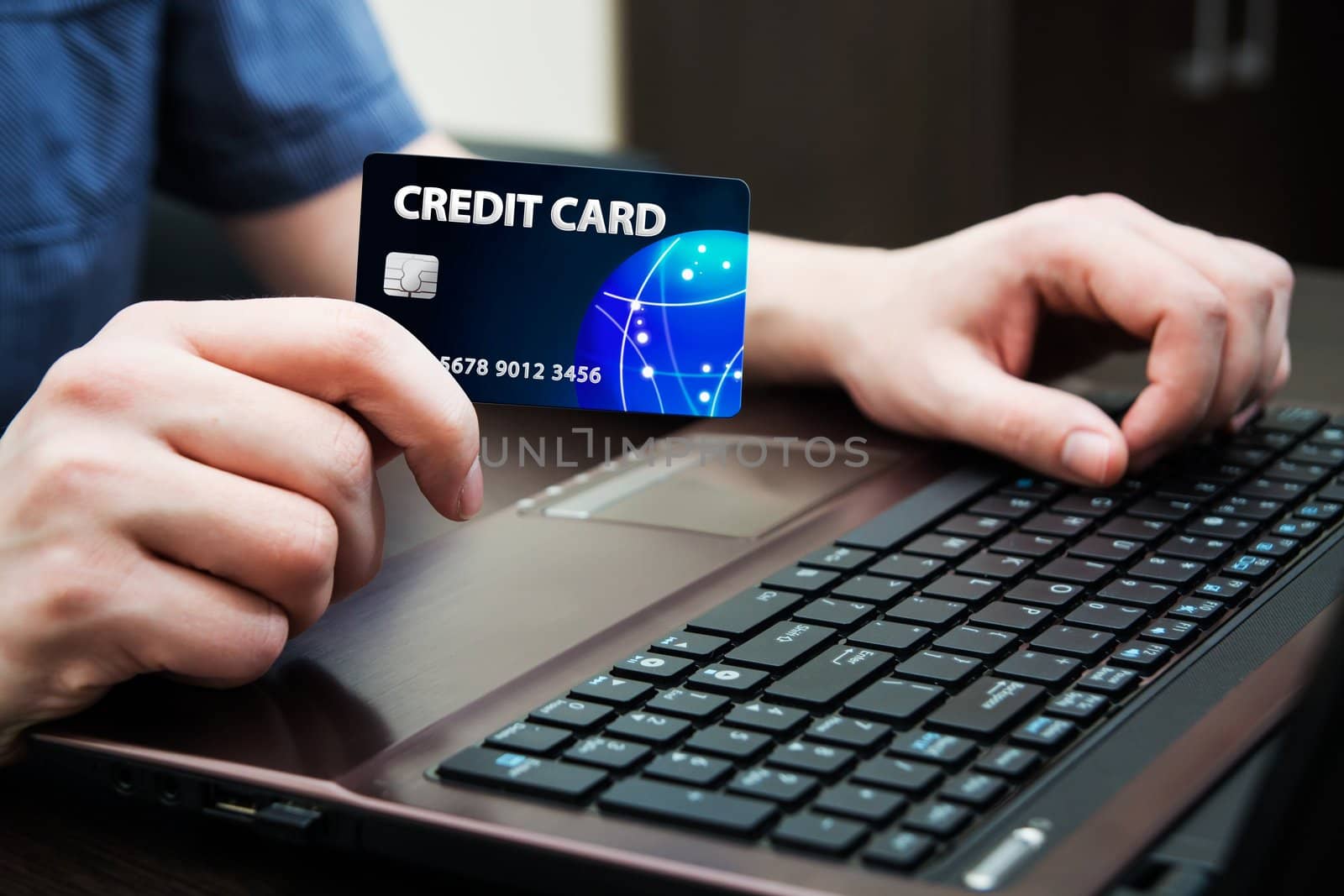 Man holding colorful credit card. Hands on computer keyboard