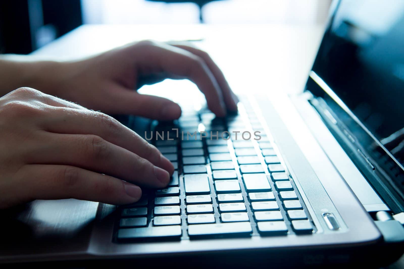 Close-up of human hands on keyboard